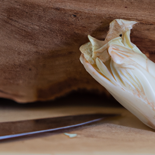 An image showcasing a rustic wooden cutting board adorned with freshly peeled chicory root, revealing its vibrant white flesh