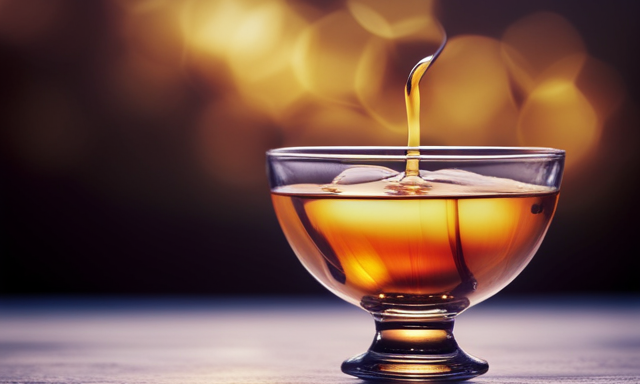 An image featuring a milky golden tea swirling in a glass teacup, adorned with delicate honeycomb patterns
